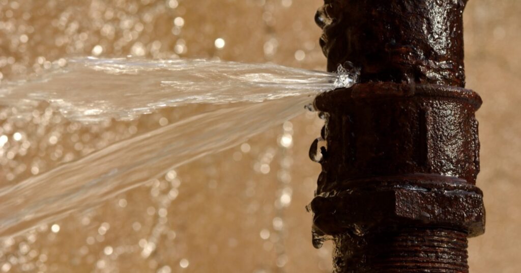 a rusty pipe with water coming out of it