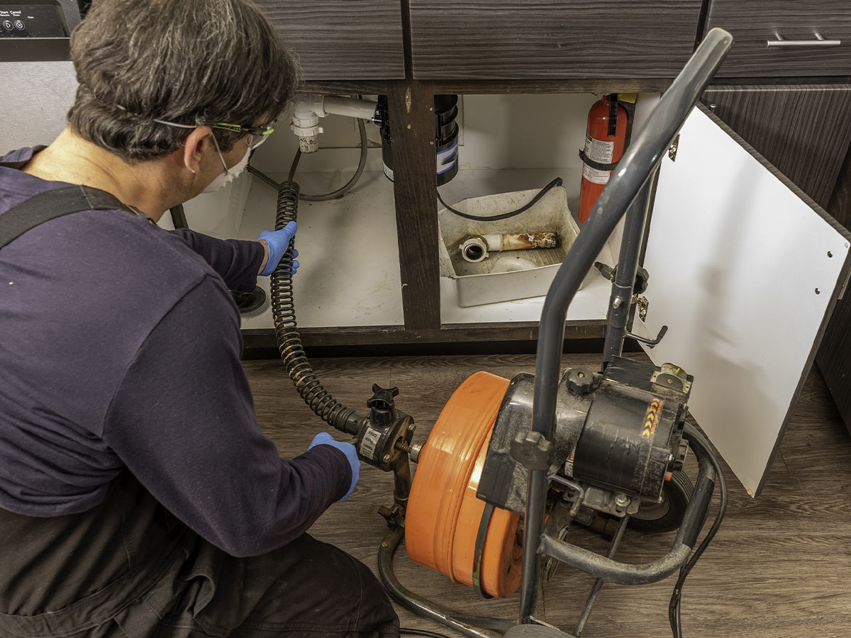 someone snaking a drain