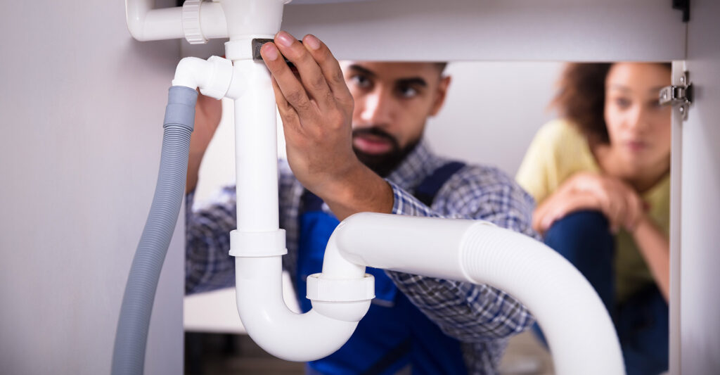 a plumber working under a sink