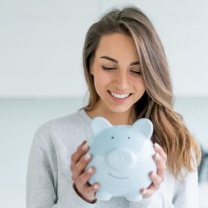 a woman holding a piggy bank