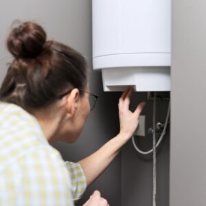 a woman working on her water heater