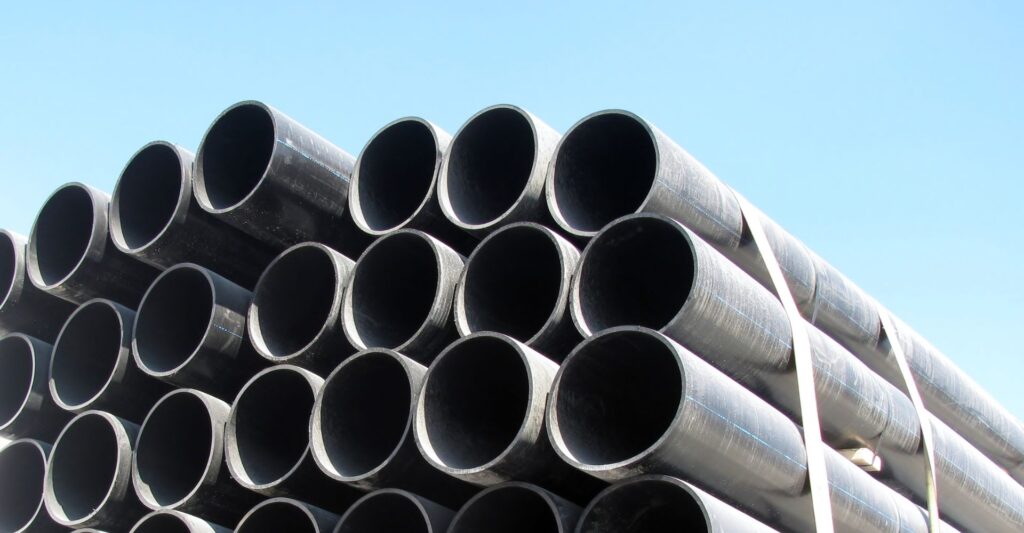 a stack of black pipes against a blue sky