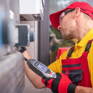 a plumber using tools to look at a pipe