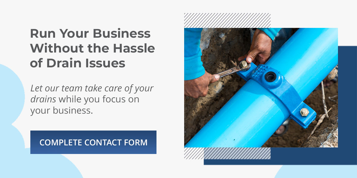 Plumber fixing underground pipes for a business